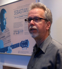 Gary Jones standing in front of poster